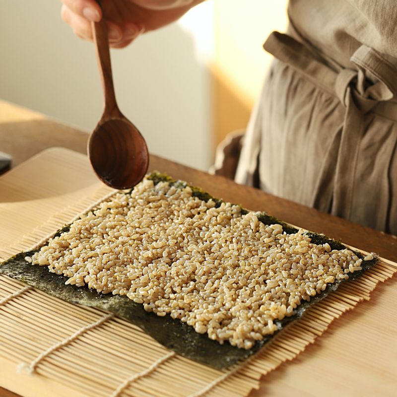 김발에 김을 올리고 밥을 고루 편 후, 나물과 고추 장아찌, 달걀 지단을 올려 김밥을 말아주세요.