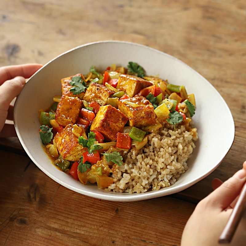 그릇에 현미밥과 두부 카레를 담고 기호에 따라 고수를 얹어 맛있게 즐겨주세요.