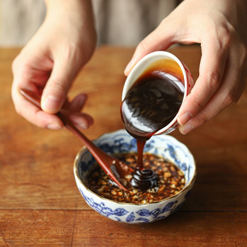 볼에 양념 재료를 넣고 섞어주세요. 달군 팬에 식용유를 두른 후 다진 마늘과 양배추를 넣어 볶아주세요.