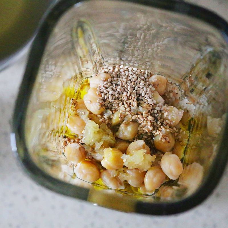 믹서에 병아리콩 삶은 물 1컵, 병아리콩, 양념 재료를 넣고 갈아주세요. 그릇에 담고 고운 고춧가루와 타임, 올리브오일을 뿌려주세요.