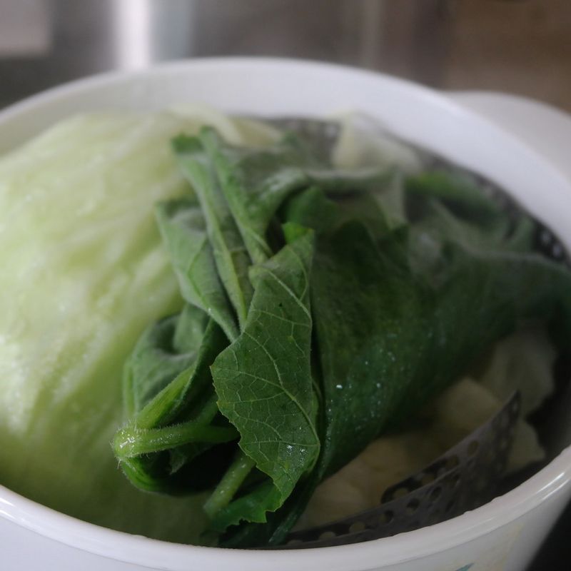 곰취는 대를 잘라내고 양배추는 가운데 심지 부분을 제거한 후 한 장씩 떼어서 준비해주세요.
찜기에 물을 붓고 가열해 끓어오르면 양배추를 아래에 깔고 곰취를 위에 올려준 후 뚜껑을 덮고 5분간 쪄주세요. 불을 끄고 뚜껑을 덮은 상태에서 남아있는 열로 약 5분가량 더 익힌 후 한 김 식혀주세요.