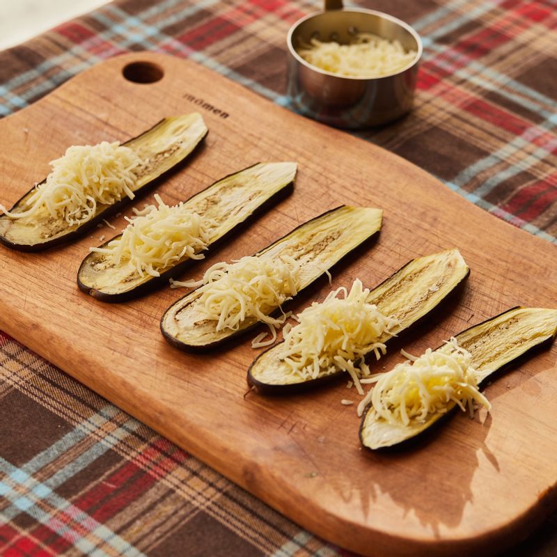 구운 가지에 슈레드 모짜렐라 치즈를 적당량 넣어 돌돌 말아주세요.