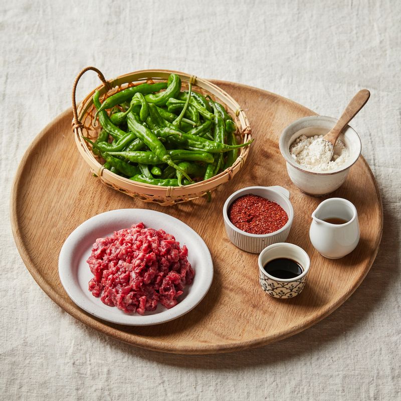 소고기 꽈리고추찜을 위한 재료 이미지로 다진 쇠고기,꽈리고추, 밀가루,맛술,후춧가루 등으로 구성 되어있습니다.