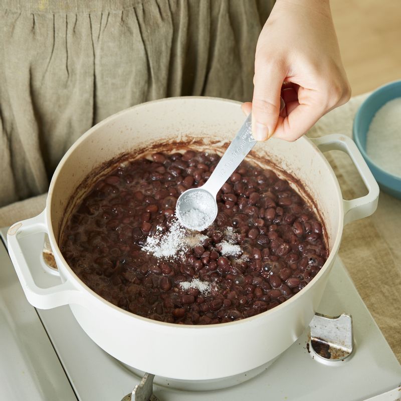 팥이 익으면 설탕과 소금을 넣고 저어가며 졸여주세요. 졸인 팥은 냉장실에서 차게 식혀주세요.
(tip. 팥을 손으로 눌렀을 때 부드럽게 으깨질 때까지 익혀주세요)
(tip. 물기가 약간 자작하게 남아있을 때 불을 끄면 팥빙수에 올리기 좋은 질감으로 굳어요)