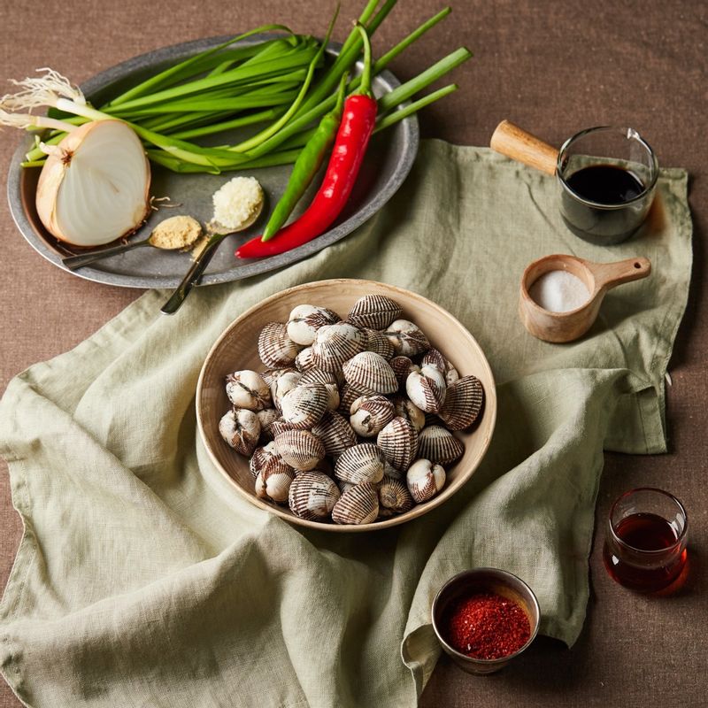 꼬막비빔밥을 위한 재료 이미지로 새꼬막,밥,참기름,통깨 등으로 구성 되어있습니다.