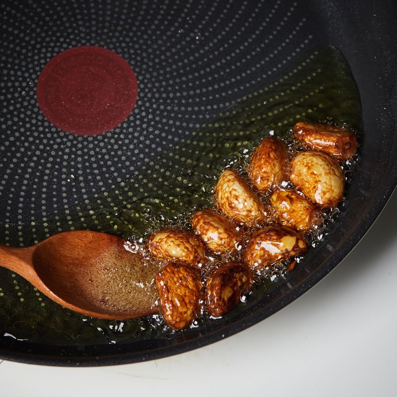 팬에 올리브오일을 두른 후 통마늘을 넣고 5단에서 6분30초간 익혀주세요.