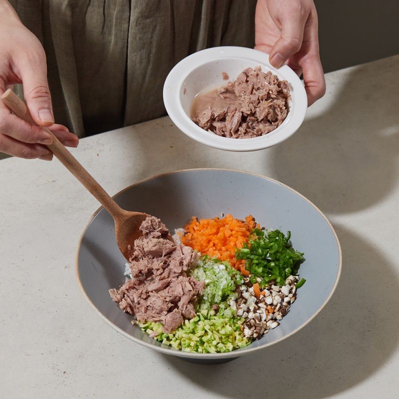 볼에 다진 채소와 참치, 참치 기름 1개 분량을 넣고 소금 후추로 간을 해 섞어주세요.
(tip. 부침가루와 참치에 이미 간이 되어 있으니 소금은 조금만 넣어주세요)