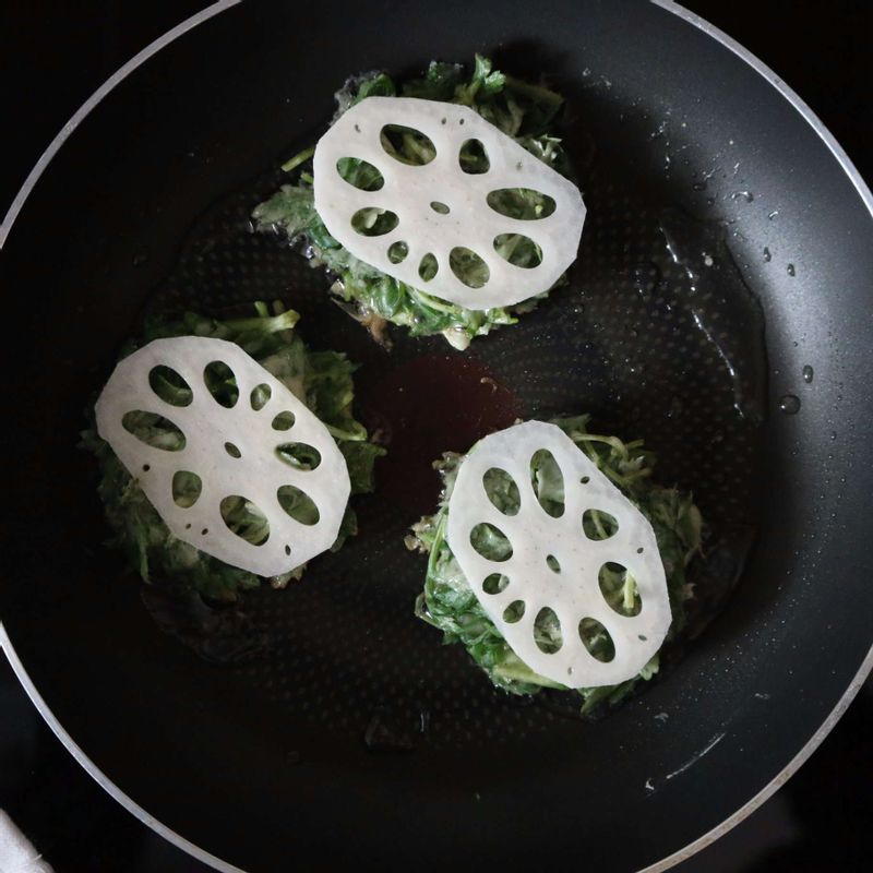 달군 팬에 식용유를 두르고 쑥전 반죽을 넣고 연근을 올린 후 노릇하게 구워주세요.