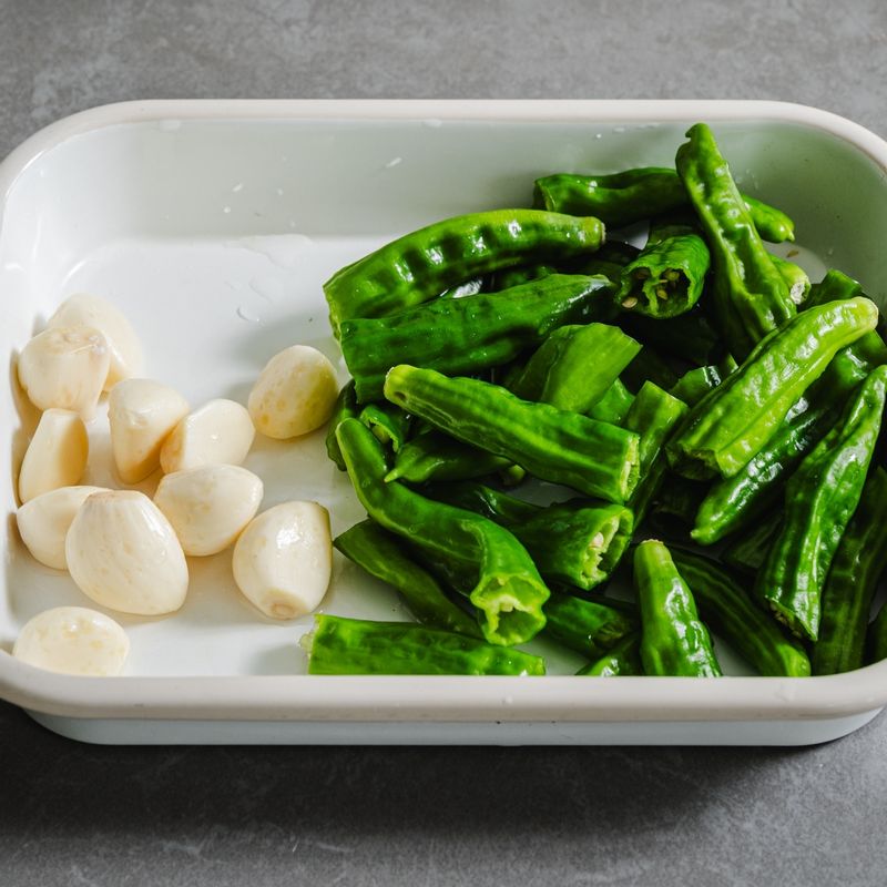 꽈리고추는 꼭지를 떼고 반으로 잘라주세요. 마늘은 꼭지를 떼주세요.