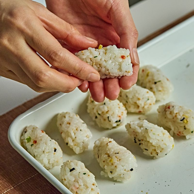 밥을 한 입 크기로 쥐고 전복을 올린 뒤, 잘라 둔 김으로 감싸 완성해주세요.