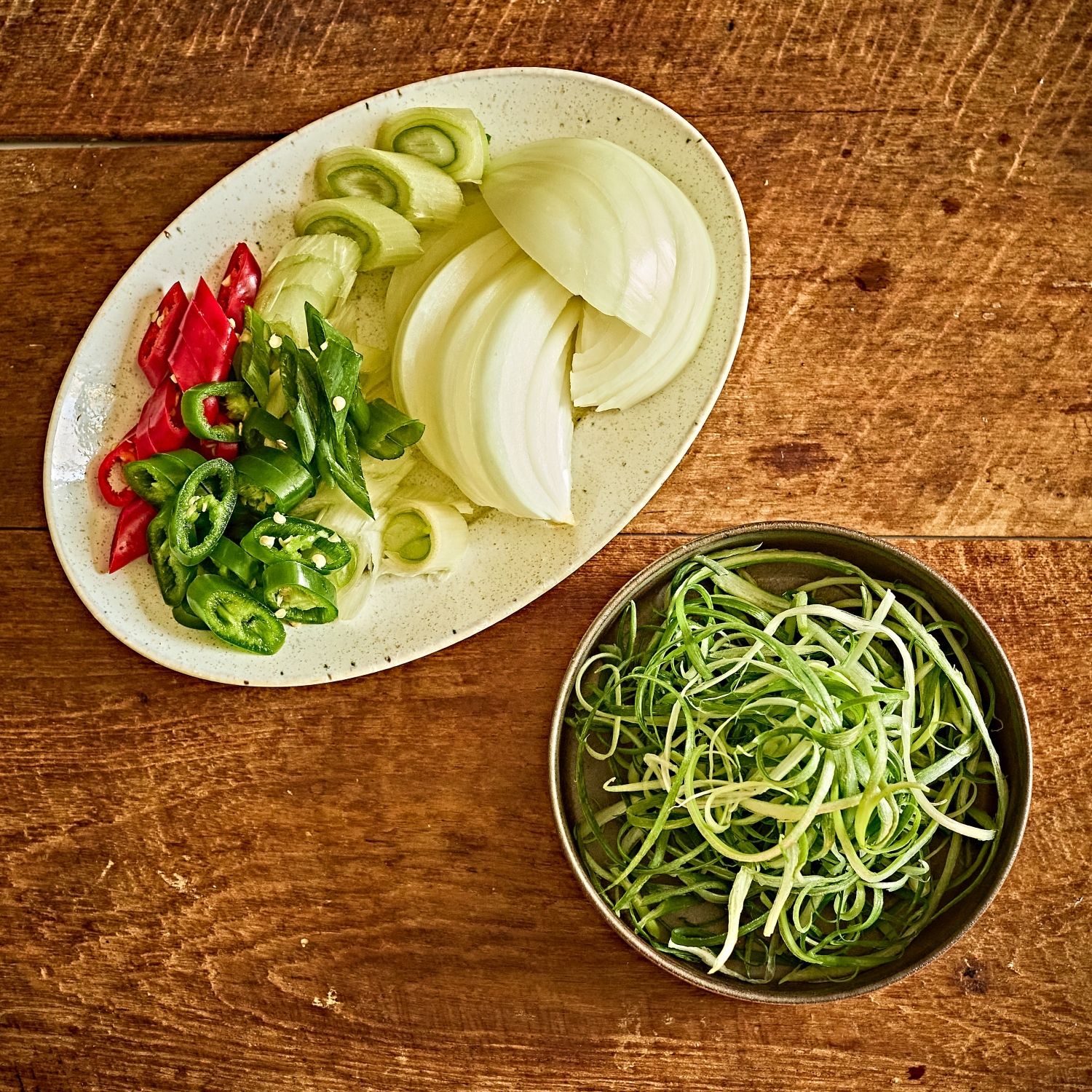 양파는 채 썰고, 대파 1/2대와 청홍고추는 어슷 썰어주세요. 남은 대파는 파채로 썰어주세요.

