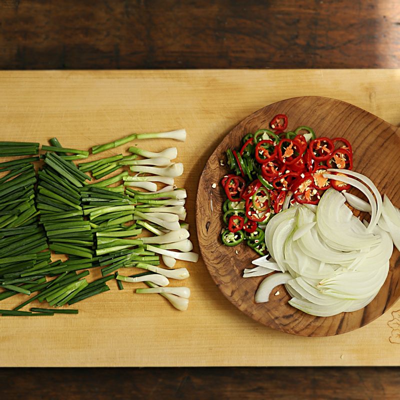 쪽파는 4cm 길이로 썰고, 양파는 채를 썰어주세요. 청양고추와 홍고추는 얇게 링으로 썰어주세요.