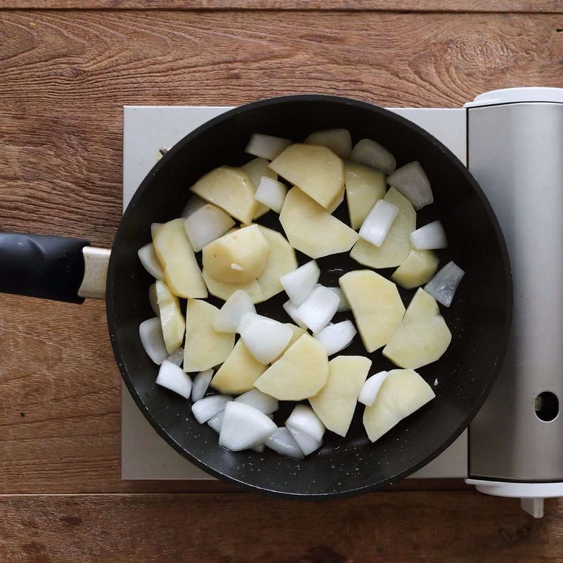 달군 팬에 약간의 기름을 두른 후 감자를 넣고 3분 정도 볶다가 양파와 양념재료를 넣어 볶아주세요.
