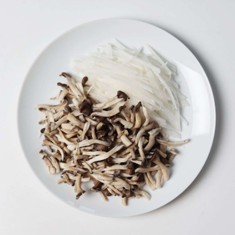 무는 얇게 채썰고, 느타리 버섯은 깨끗이 씻어 잘게 찢어 준비해주세요. 돼지고기에는 청주 1큰술, 후춧가루 약간, 소금 한꼬집을 넣어 밑간 해주세요.