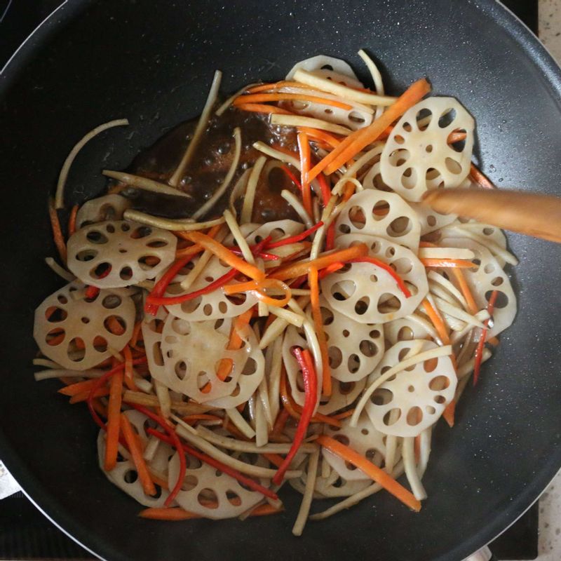 팬에 식용유를 두르고 연근과 우엉을 볶아주세요. 반쯤 익었을 때 당근, 홍고추, 양념 재료를 넣어서 볶다가 참기름과 통깨를 뿌려 마무리해주세요.