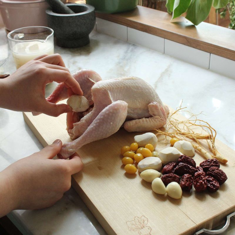 찹쌀을 넣은 닭의 속에 대추, 깐 은행, 깐 마늘, 미삼을 넣고 마지막으로 깐 밤을 넣어 재료들이 흘러나오지 않게 막아주세요.