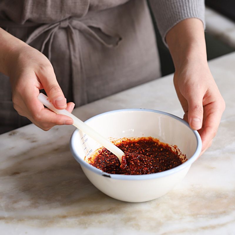 볼에 오징어, 무절임, 어슷하게 썬 대파, 무침 양념 재료를 넣고 골고루 버무려주세요.