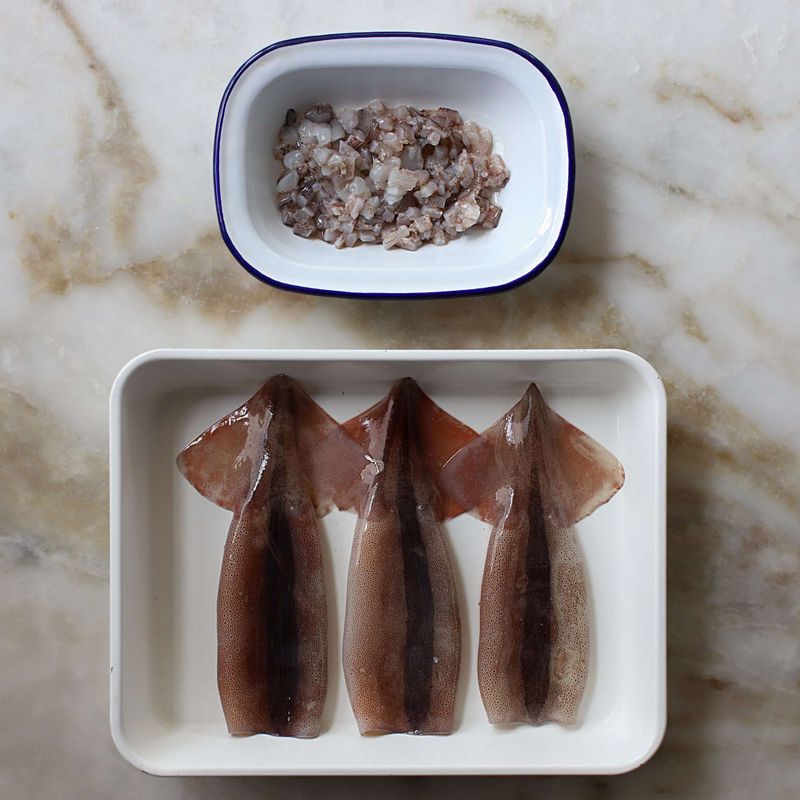 오징어는 배를 가르지 않고 다리를 당겨 내장을 꺼내어 속을 깨끗이 씻어주세요. 오징어 다리는 잘게 다져 물기를 제거해주세요.