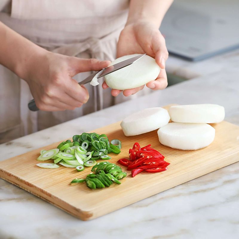 무는 2센치 두께로 동그랗게 자른 후 모서리를 다듬고 홍고추, 청양고추와 대파는 어슷하게 썰어주세요.