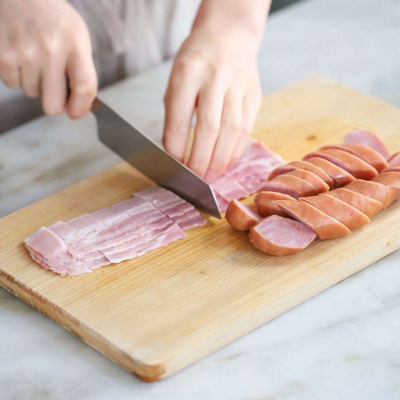 소시지는 한 입 크기로 어슷하게 썰고, 베이컨도 먹기 좋은 크기로 썰어주세요.