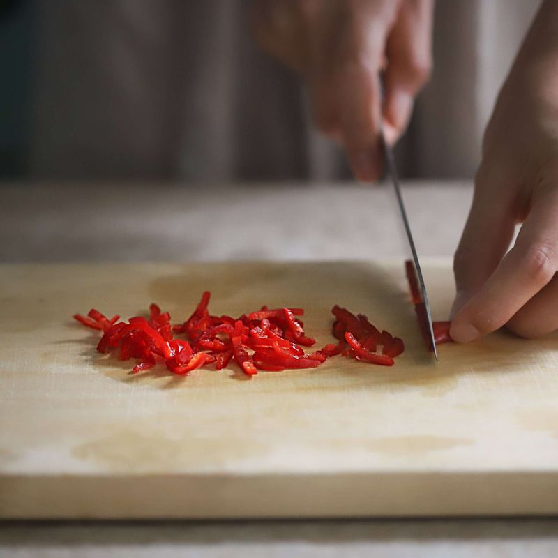 홍고추는 반으로 잘라 씨를 뺀 후 2cm길이로 얇게 채썰어주세요. 볼에 양념재료를 모두 넣어 섞어주세요.