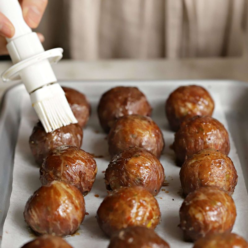 접시에 주먹밥을 담고 먹기 직전에 소스를 한번 더 바른 후 통깨를 뿌려주세요.
(먹기 좋게 주먹밥을 반으로 잘라 드셔도 좋답니다.)
tip 팬을 이용하실 때는 달군 팬에 식용유를 두르고 고기로 감싼 이음새 부분이 아래로 가도록 놓고 앞 뒤로 굴려가며 중약불에서 익힌 후 마지막에 소스를 넣고 윤기나게 졸여주세요.