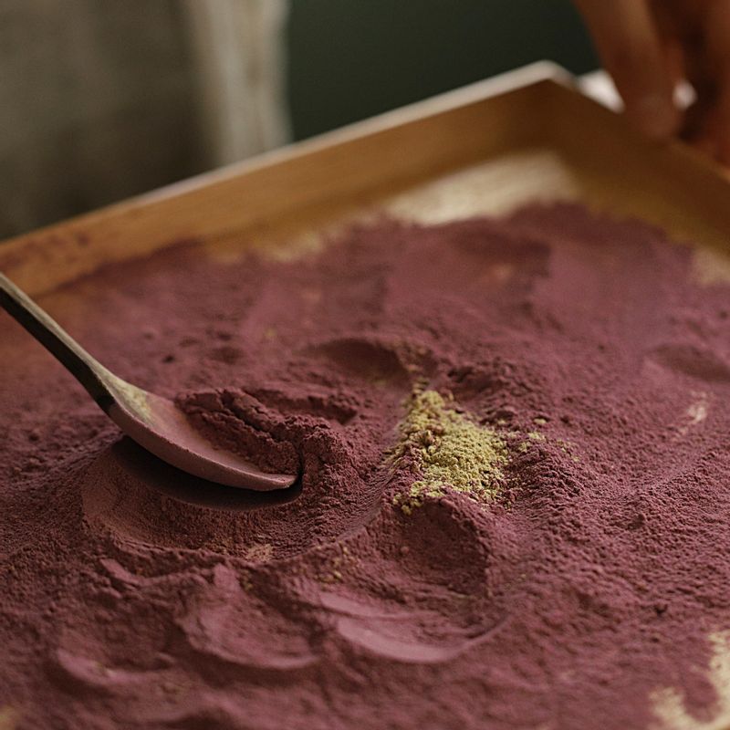 트레이에 자색 고구마 재료를 섞어 넣고 고구마 반죽을 굴려가며 가루를 묻혀주세요.