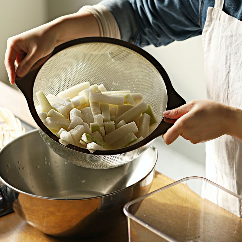 밀폐용기에 절인 무 (절이면서 나온 물), 배, 양파, 대파, 쪽파, 청양고추, 홍고추를 넣고 동치미 국물을 부어주세요.